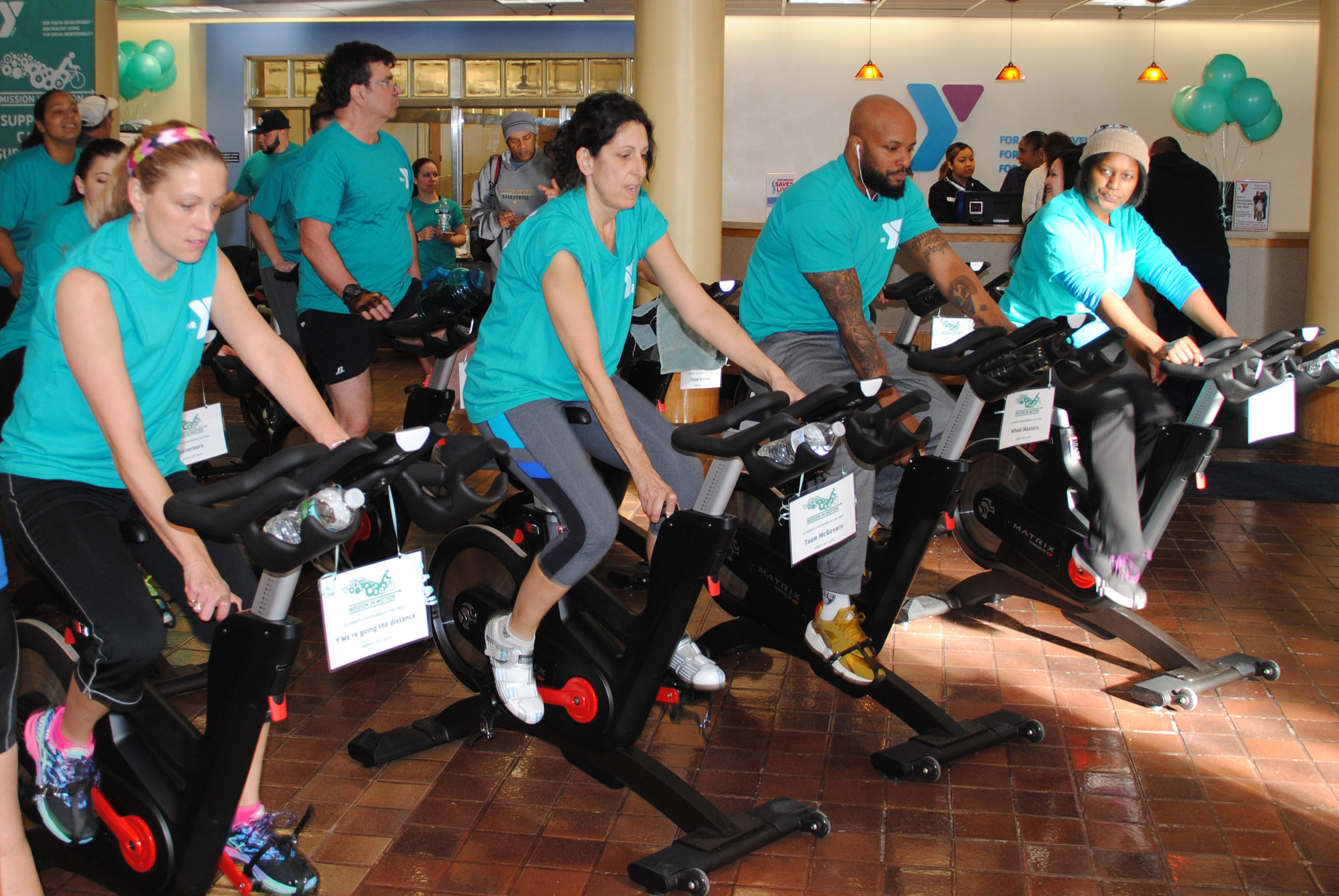 A group of individuals using exercise bikes during the LIVESTRONG event in Central Massachusetts.