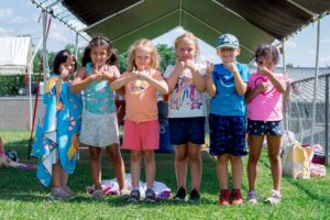 Group of young girls posing for a picture at a summer camp in Central Massachusetts