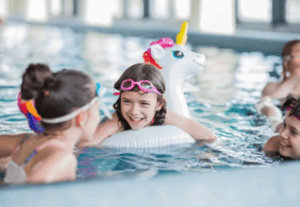 Kids enjoying themselves in the pool at a swimming pool party in Central Massachusetts